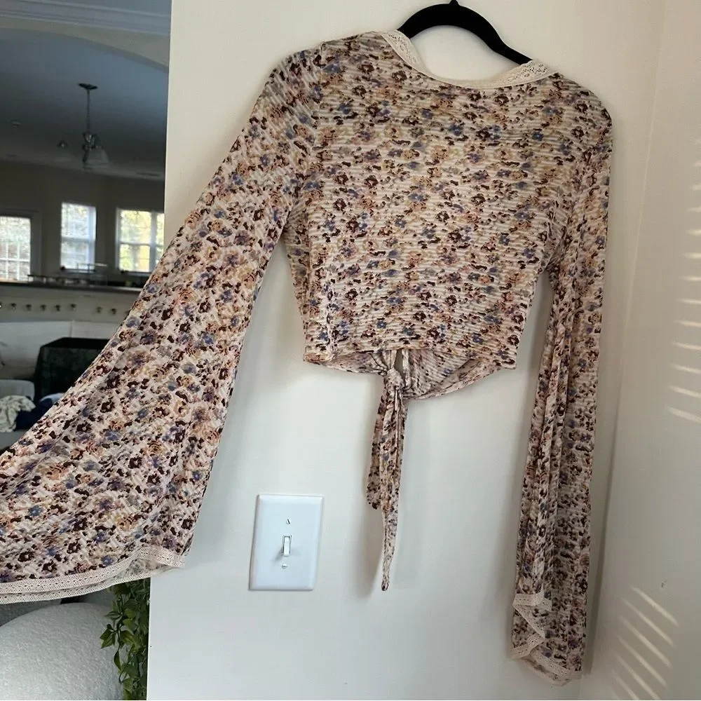 Free People cream and floral clasp front top w tie in front and bell sleeves